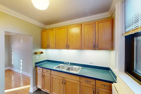 A kitchen with wooden cabinets and a blue countertop.