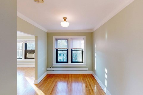A room with a wooden floor and a window.