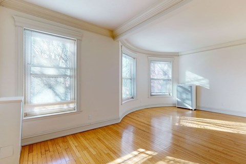 A room with wooden floors and white walls.
