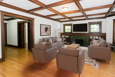 A living room with a fireplace and a TV.
