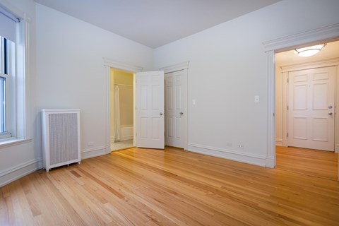 A room with wooden floors and white walls.