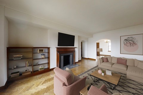 A living room with a fireplace and a television on the wall.
