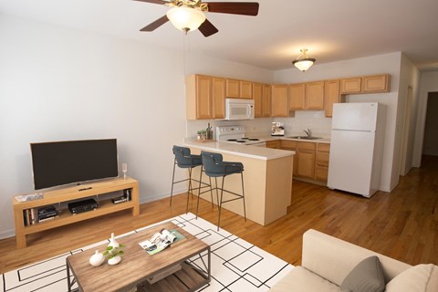 A modern kitchen with wooden cabinets and a white refrigerator.
