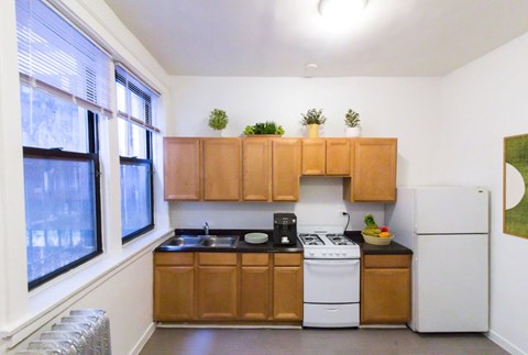 A kitchen with wooden cabinets and white appliances.
