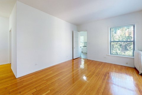 A room with wooden floors and white walls.