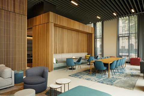 A modern conference room with a long table and chairs.