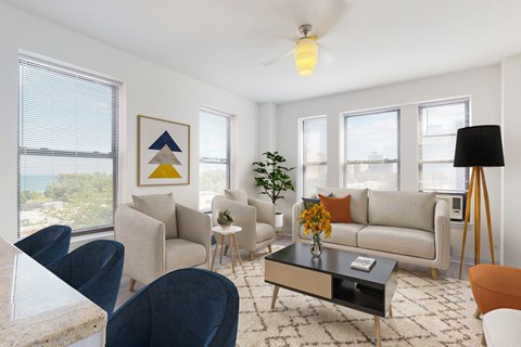 A living room with a grey couch, a coffee table, and a painting on the wall.