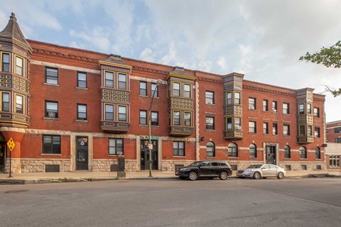 A row of red brick buildings with black and white trim.