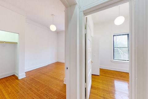 A room with wooden floors and white walls.