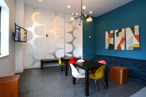 A modern dining room with a black table and chairs.