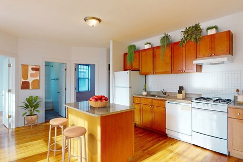 A kitchen with wooden cabinets and a white refrigerator.