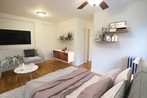 A living room with a grey couch and a white coffee table.