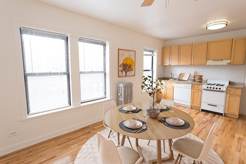 A dining room with a table set for four.