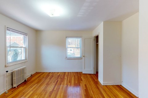 A room with wooden floors and white walls.