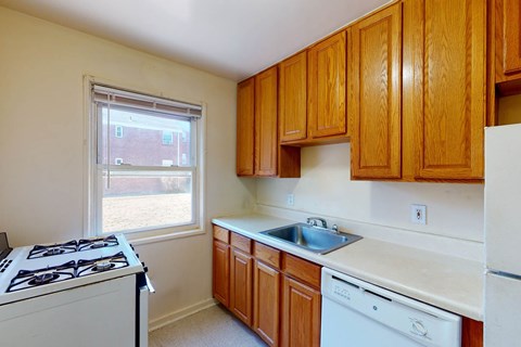 A kitchen with wooden cabinets and white appliances.