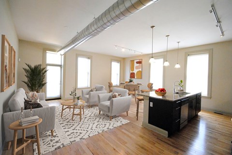 A modern living room with a black countertop and white furniture.