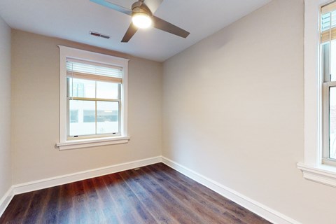 A room with a ceiling fan and a window.