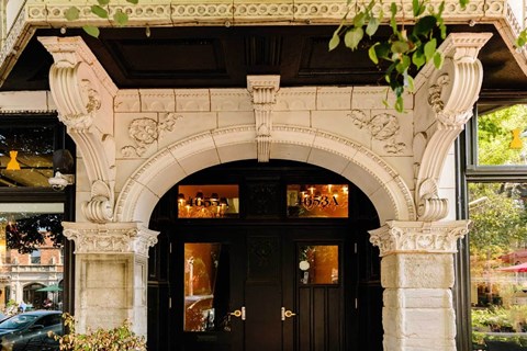 A building with a black door and a sign that reads 1653A.