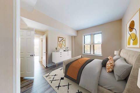 A living room with a grey couch and a white cabinet.