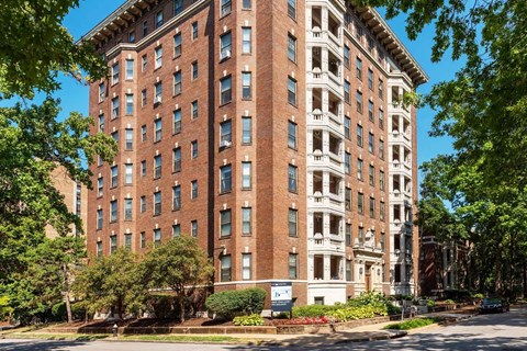 A large red brick building with a blue sky in the background.