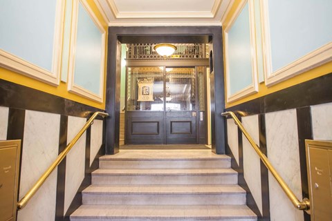 A staircase with a black and white striped wall on the side.