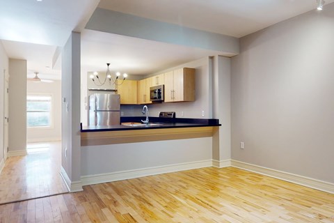 A kitchen with wooden floors and a countertop.