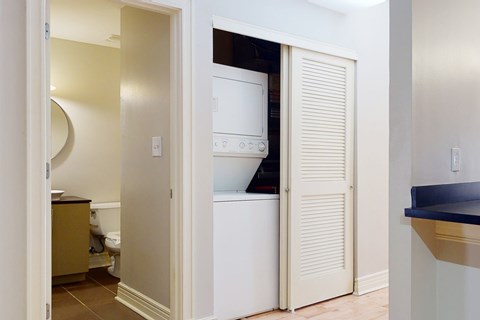 A white refrigerator is in a kitchen pantry.
