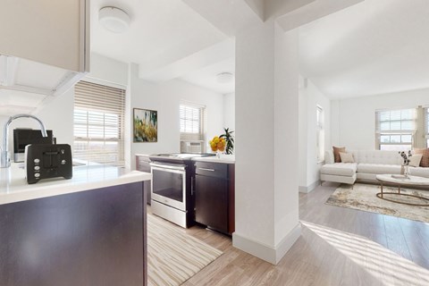 A modern kitchen with a black refrigerator and stove.