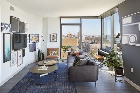 A living room with a couch, chair, and a table with a plant on it.