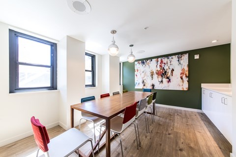 A dining room with a table and chairs.