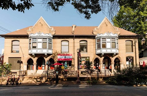 A building with a red and white striped awning is in the foreground.