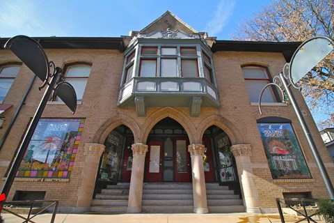 A building with a red door and a balcony.