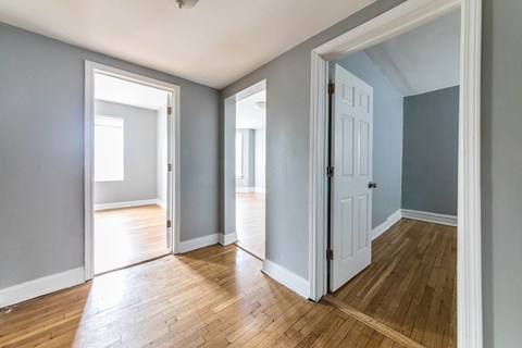 A room with wooden floors and white doors.
