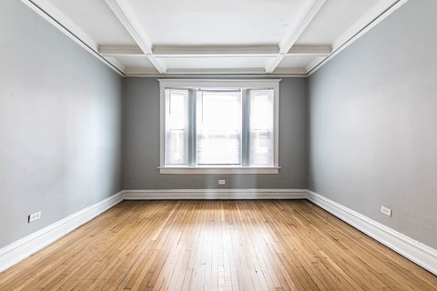 A room with wooden floors and a window.