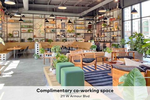 A co-working space with a variety of seating options and plants.