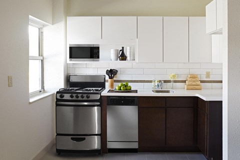 A modern kitchen with a stainless steel oven and microwave above the stove.