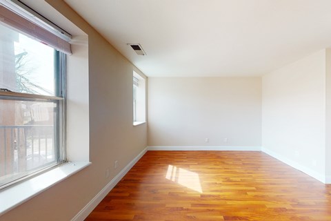 A room with wooden floors and white walls.