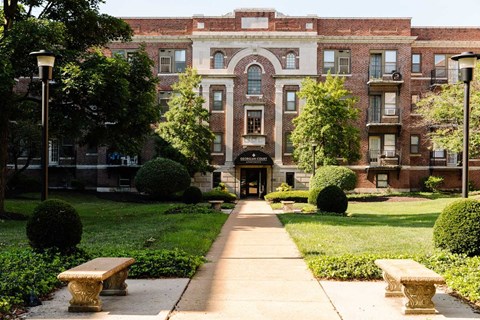 A large brick building with a walkway in front of it.