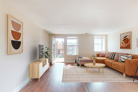 A living room with a brown couch and a wooden cabinet.