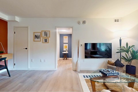 A living room with a flat screen TV on the wall.