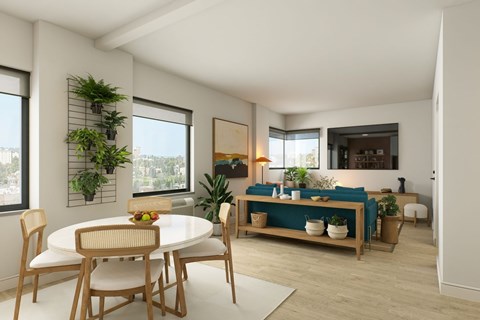 A dining room with a white table and chairs.