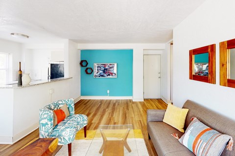 A living room with a couch, chair, and coffee table.