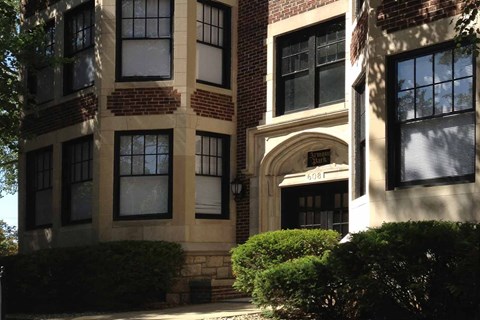 A building with a brick facade and a black door.