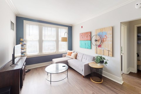 A living room with a white couch and a coffee table.