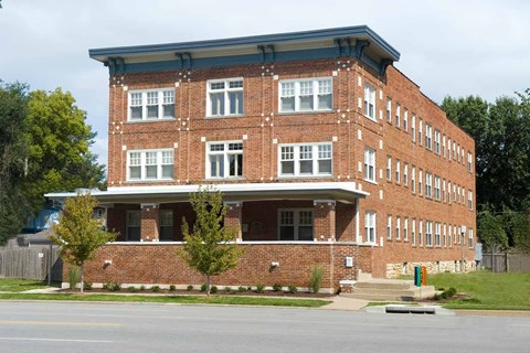A red brick building with a blue roof and white trim.