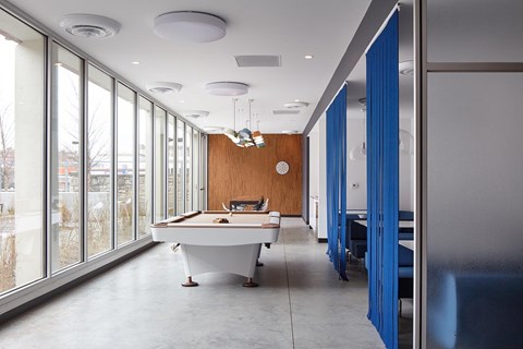 A conference room with a long table and chairs.