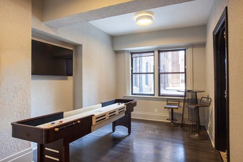 A room with a pool table and a chair.