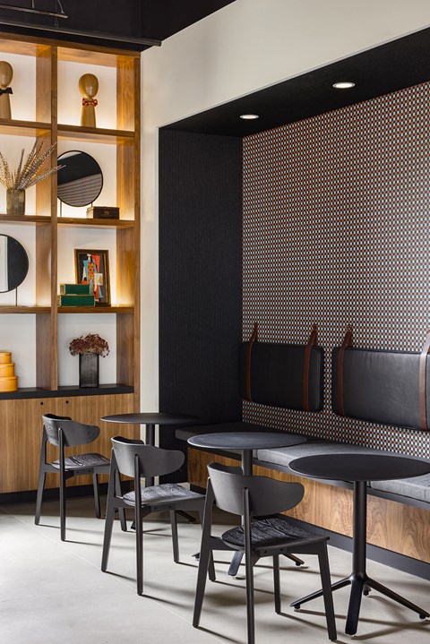 A black and white dining room with a wooden shelf and chairs.