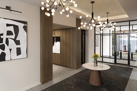 A modern living room with a large abstract painting on the wall and a chandelier hanging from the ceiling.