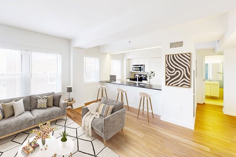A modern living room with a grey sofa and a coffee table.